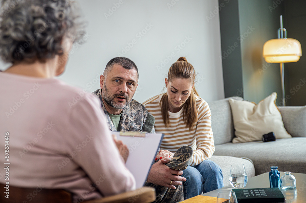 Soldier with his wife having therapy meeting with senior female psychologist. Soldier with his wife having therapy meeting with senior female psychologist.