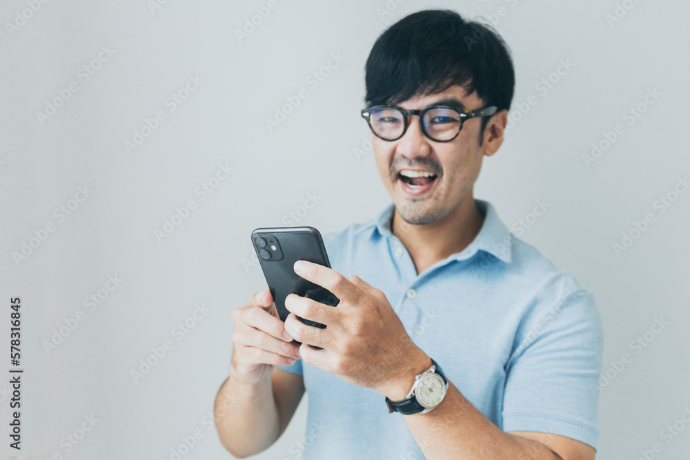 adult asian man using mobile, cell phone.young male person.posing smiling laughing look excited surprised thinking positive happy.empty,copy space for text advertising.white background adult asian man using mobile, cell phone.young male person.posing smiling laughing look excited surprised thinking positive happy.empty,copy space for text advertising.white background