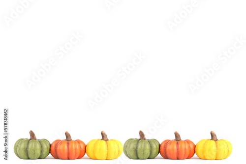 A frame filled with a row of colorful pumpkins made out of clay isolated on white 
