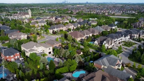 Drone shot circling over sunny houses and yards in Kleinburg. photo