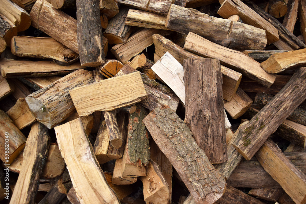 Lots of chopped oak firewood. Natural background. Lots of chopped oak firewood. Natural background.