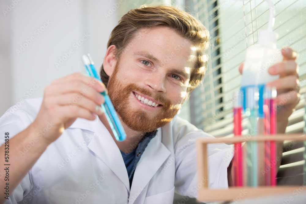 scientist with flasks containing colorful chemistry liquids scientist with flasks containing colorful chemistry liquids