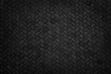 Old black bamboo weave texture background, pattern of woven rattan mat in vintage style.