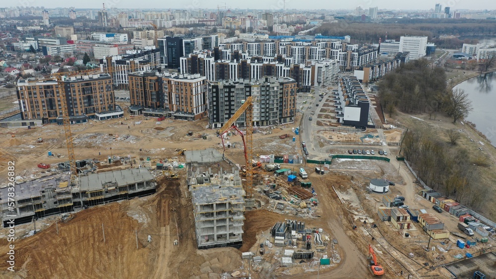 Construction of a new innovative residential high-rise block in Minsk. Life with a view of the construction site from the window. Rapid construction of residential buildings in Europe.