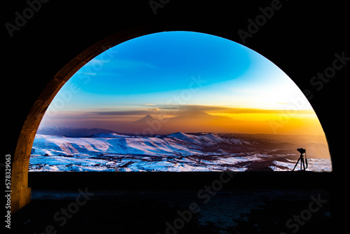 Arch and beautiful sunset. Mount Ararat and golden sunset can be seen through the arch