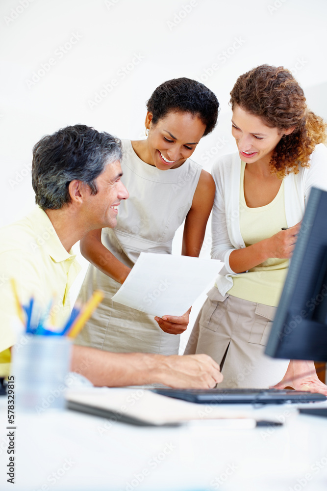 Business people taking a look at paperwork. Smiling business people at work with woman holding paperwork. Business people taking a look at paperwork. Smiling business people at work with woman holding paperwork.