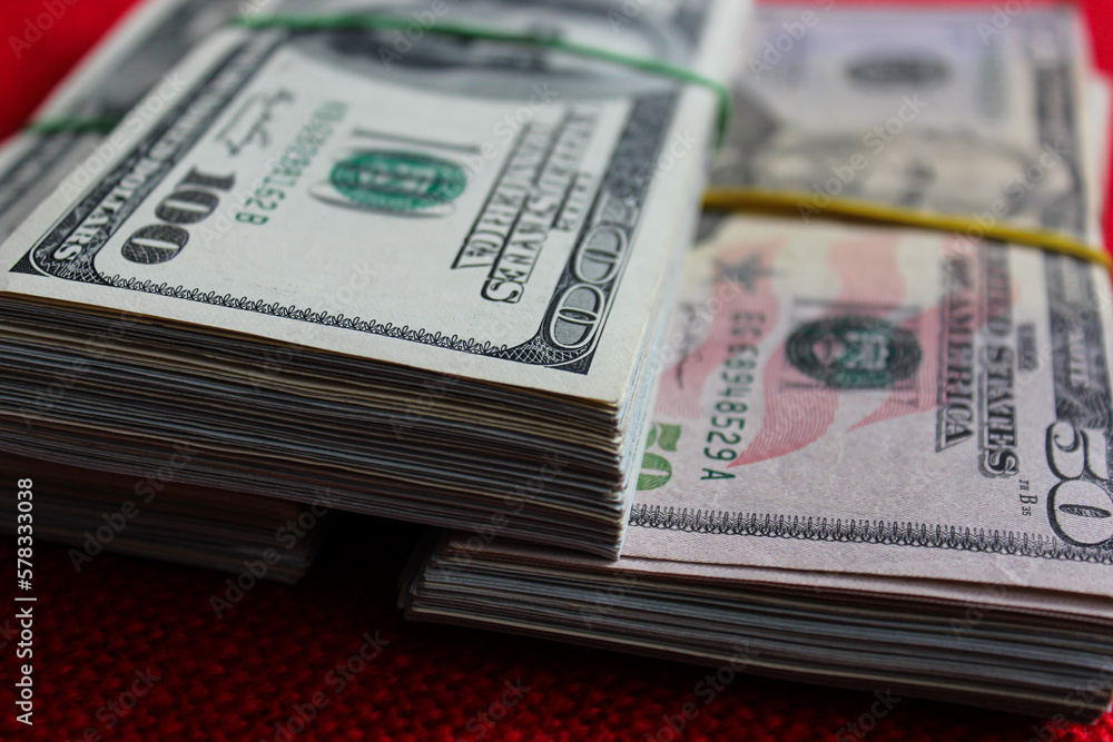 Three stacks of dollars. A lot of 100 and 50 dollar bills, close up Three stacks of dollars. A lot of 100 and 50 dollar bills, close up