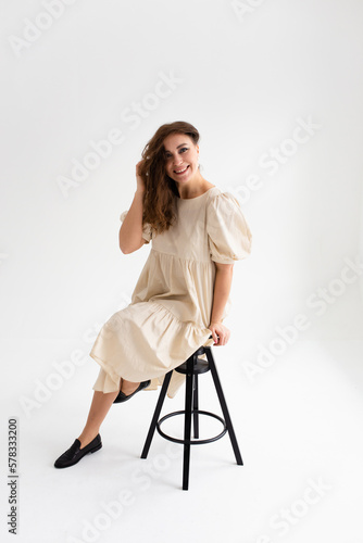 Beautiful young woman with long hair in a photo studio. 