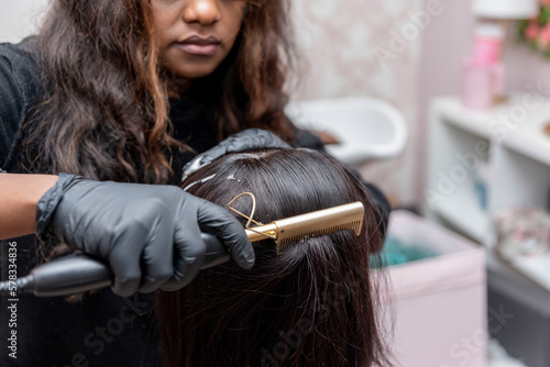 close up of african american female Student learning hairdresser with a mannequin head