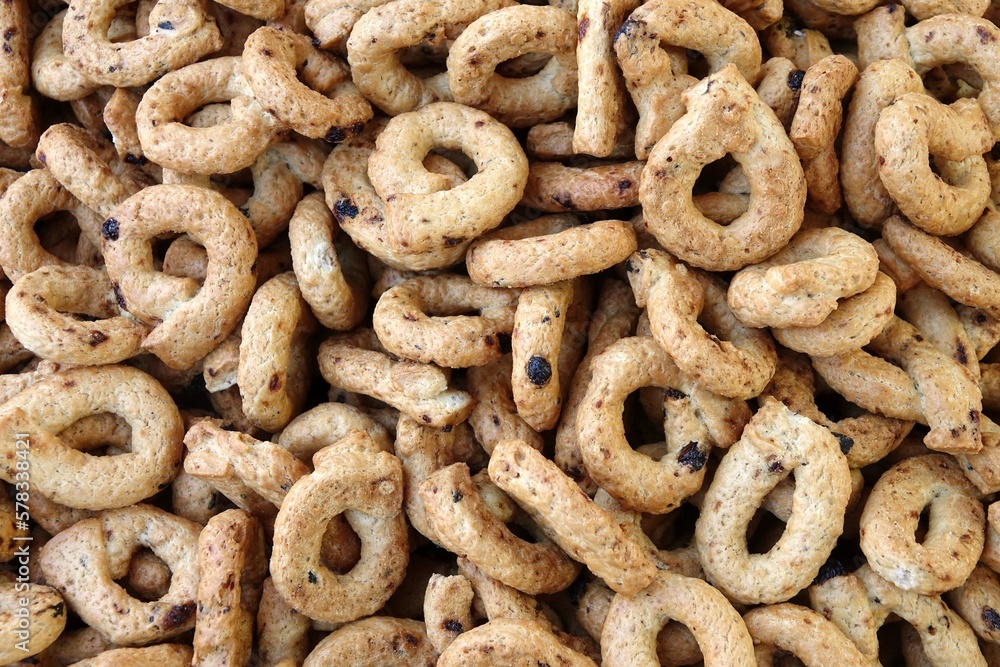 close up image of a pile of handmade artisanal taralli, a typical baked product of southern Italy close up image of a pile of handmade artisanal taralli, a typical baked product of southern Italy
