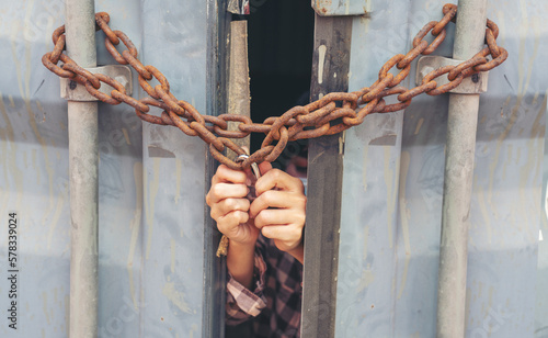 Woman trapped in cargo container wait for Human Trafficking or foreigh workers, Woman holding master key wait for holp help, woman chained to her wrist photo