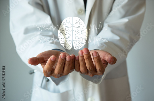 Doctor holding a brain model in his hands. Brain and brain waves illustration. Health care concept.