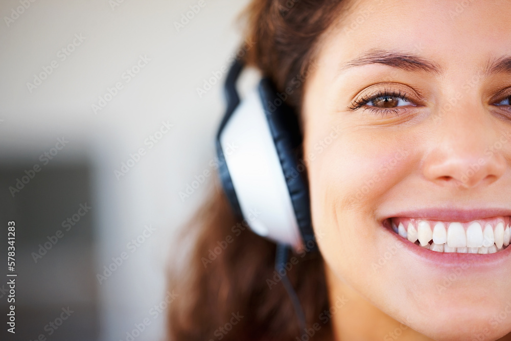 Pretty woman wearing headphones. Closeup of pretty smiling woman wearing headphones. Pretty woman wearing headphones. Closeup of pretty smiling woman wearing headphones.