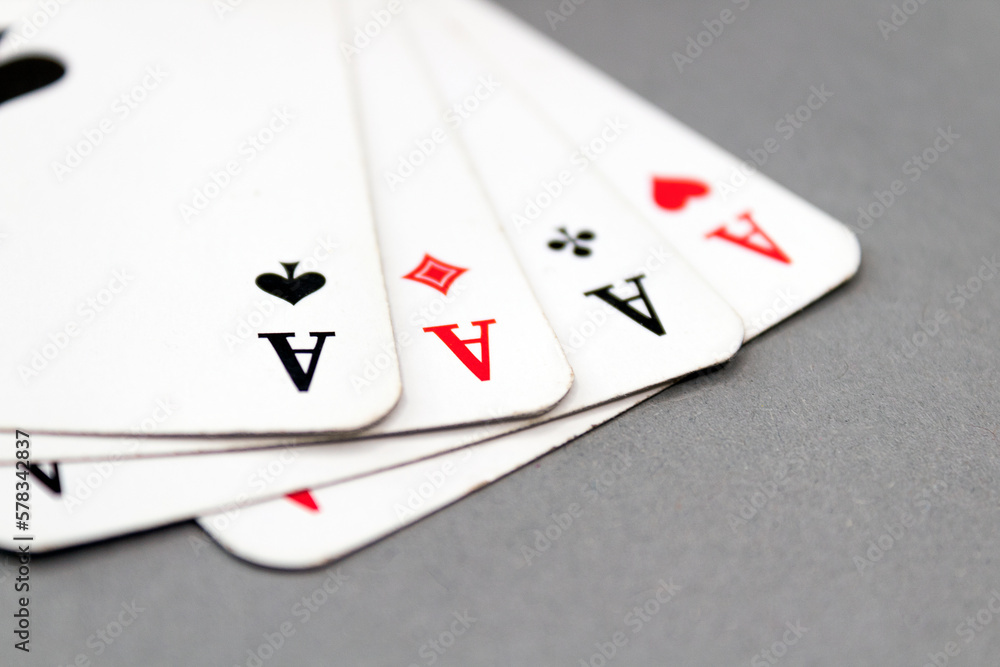 Four aces isolated on grey background