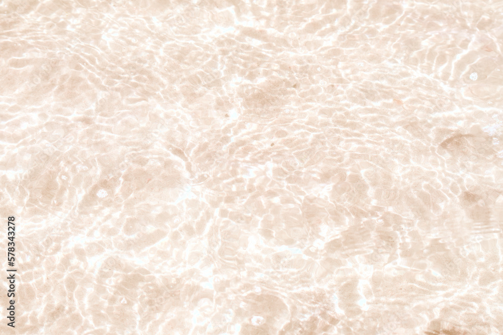Fototapeta premium A thin layer of clear water over the sand. A seaside or ecology-themed background with clear sea water over a sandy bottom.