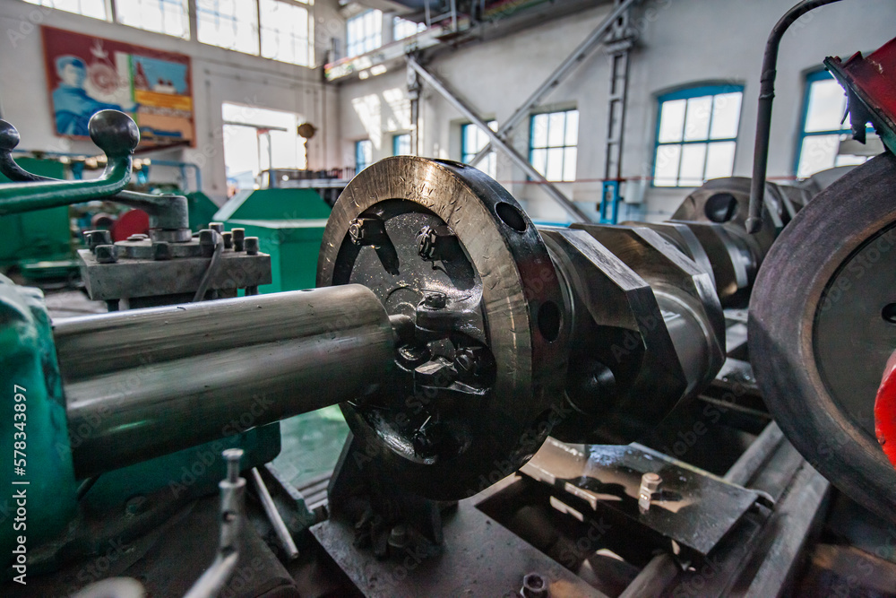 Kazaly, Kazakhstan - May 02, 2012: Restoring locomotive engine crankshaft on lathe closeup photo. Low depth of field. Kazaly, Kazakhstan - May 02, 2012: Restoring locomotive engine crankshaft on lathe closeup photo. Low depth of field.