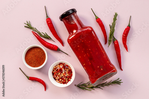 Photos Spicy chili seasoning and red ripe pepper, top view