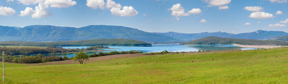 Beautiful spring lake reservoir with dam and meadow in front , Crimea, Ukraine. Beautiful spring lake reservoir with dam and meadow in front , Crimea, Ukraine.