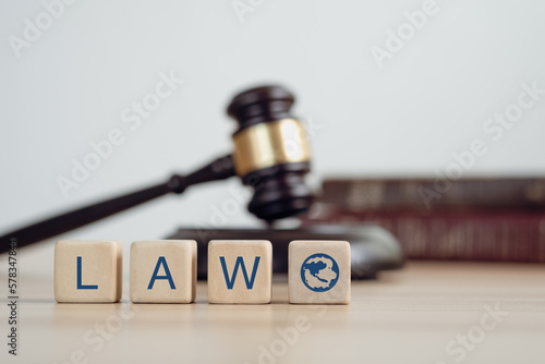 Law text on woodblock , Justice law Scales and books and wooden gavel tool on desk in Lawyer office. Law concept. . photo