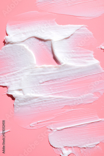 Cosmetics texture. Smear of white face or body cream, lotion, mousse, soap, shower gel on pink background. Spa, skin care, beauty and health, medicine. Cosmetic background, mockup