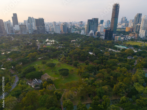 Aerial view Lumpini central park with modern office building sunset sky downtown