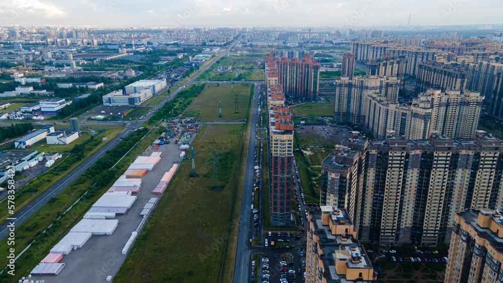 Aerial view of  residential high-rise buildings and constructing more next to park and highway in the historical and at same time modern city of St. Petersburg at sunny summer day