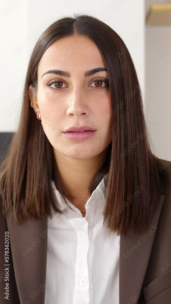 Video confident portrait of serious business woman sitting at desk office. Front view portrait of pretty female entrepreneur looking at camera. Successful people concept Video confident portrait of serious business woman sitting at desk office. Front view portrait of pretty female entrepreneur looking at camera. Successful people concept