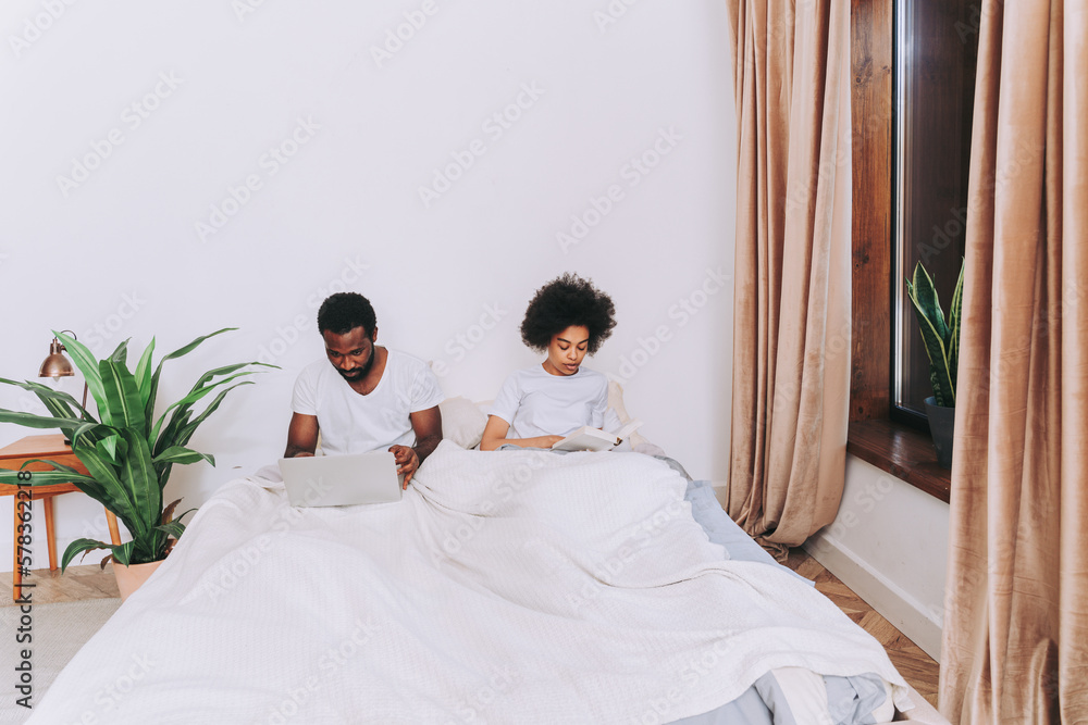 Afro american couple relaxing in bed at home Afro american couple relaxing in bed at home
