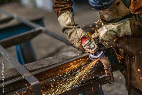 Factory worker grinding a metal,close up