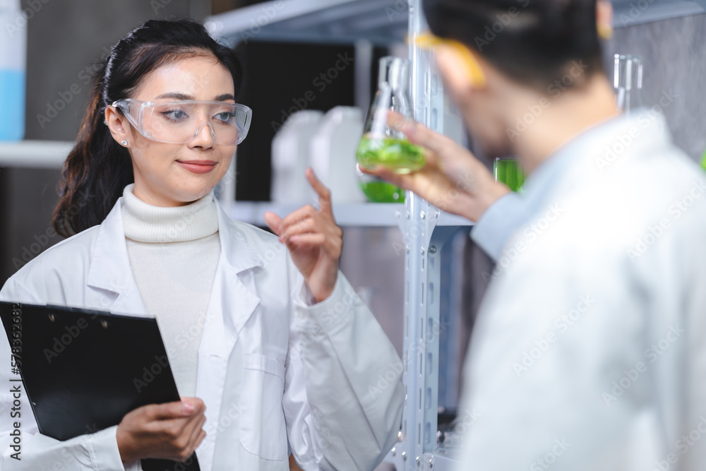 Pharmaceutical factory woman worker in protective clothing operating production line in sterile environment, scientist with glasses and gloves checking hemp plants in a marijuana farm Pharmaceutical factory woman worker in protective clothing operating production line in sterile environment, scientist with glasses and gloves checking hemp plants in a marijuana farm