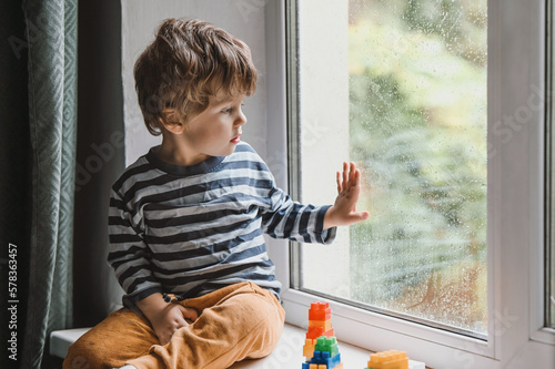 Fotografie Child playing with colorful toy blocks