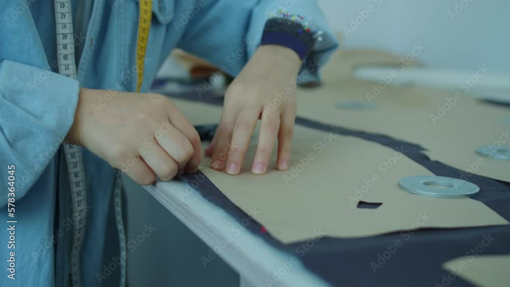 Girl working in her tailoring workshop sewing Girl working in her tailoring workshop sewing