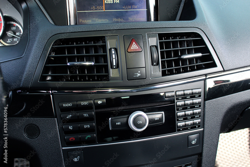 Multimedia radio cd controls. Modern car climate control panel for driver and passenger with shallow depth of field. Zone climate control. Car interior detail. Multimedia radio cd controls. Modern car climate control panel for driver and passenger with shallow depth of field. Zone climate control. Car interior detail.