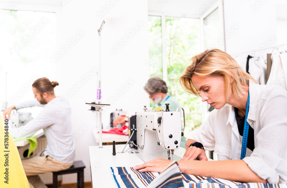 Obraz premium Team of fashion designers at work in a clothing brand start-up