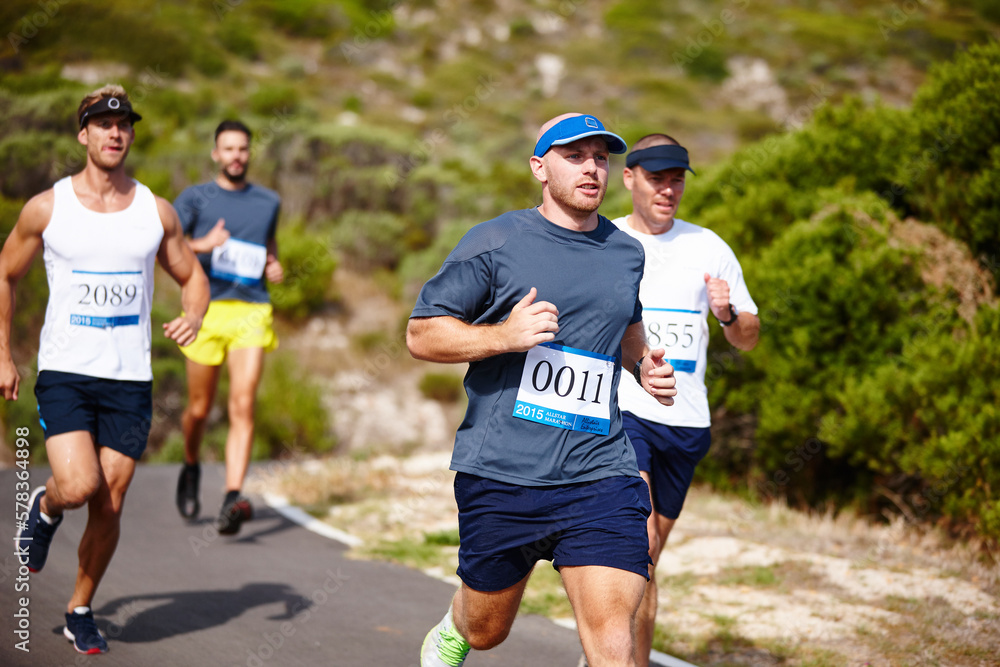 Test of endurance. a group of young men running a marathon.