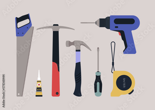 A hardware toolkit, a picker, a handsaw, a hammer, a drill, a tape measure, glue, and a screwdriver