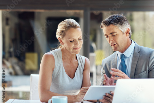 Maybe if we take a different approach. a dedicated mature business couple discussing their ideas with each other in the office to improve their work.