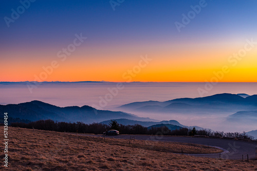 a sunset at the top of the hill