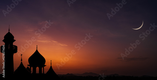 Silhouette mosques on dusk sky twilight with crescent moon over mountain  religion of Islamic and free space for text Ramadan Kareem  Eid Al Fitr  Eid Al Adha  Eid Mubarak  Muharram  Maulid