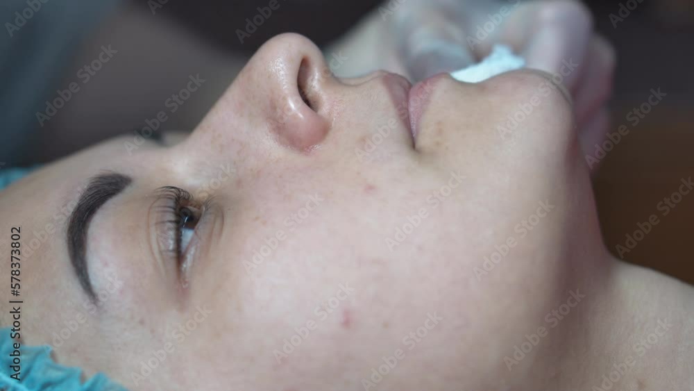 The girl applies a nourishing charcoal mask to reduce wrinkles. Close-up of a woman's face with a blue bubble clay mask. Carbonated bubble clay mask. The girl applies a nourishing charcoal mask to reduce wrinkles. Close-up of a woman's face with a blue bubble clay mask. Carbonated bubble clay mask.