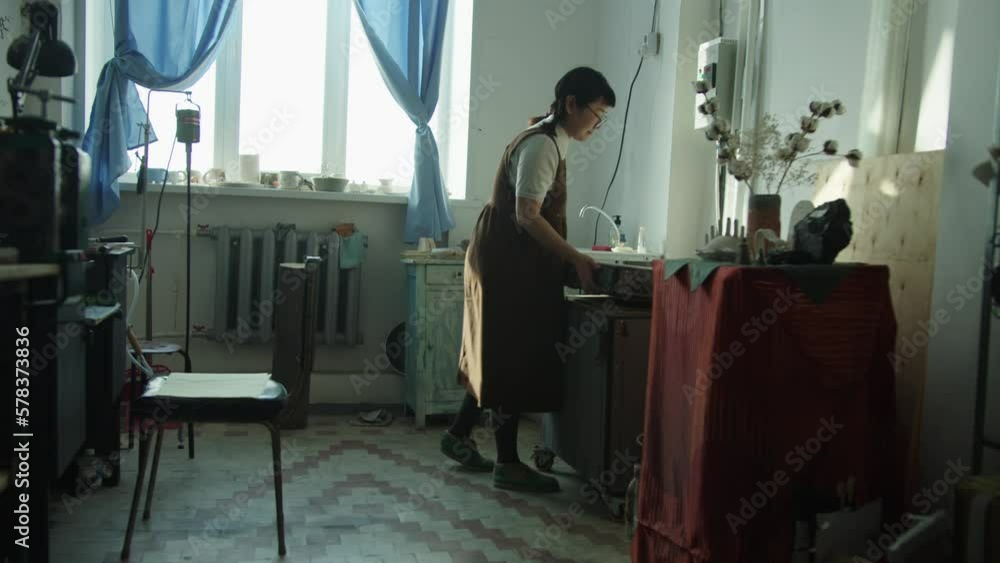 The girl works in her atmospheric craft workshop with jewellery. The girl works in her atmospheric craft workshop with jewellery.