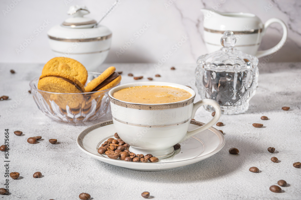 Coffee cup,coffee beans and sweets on the background Coffee cup,coffee beans and sweets on the background