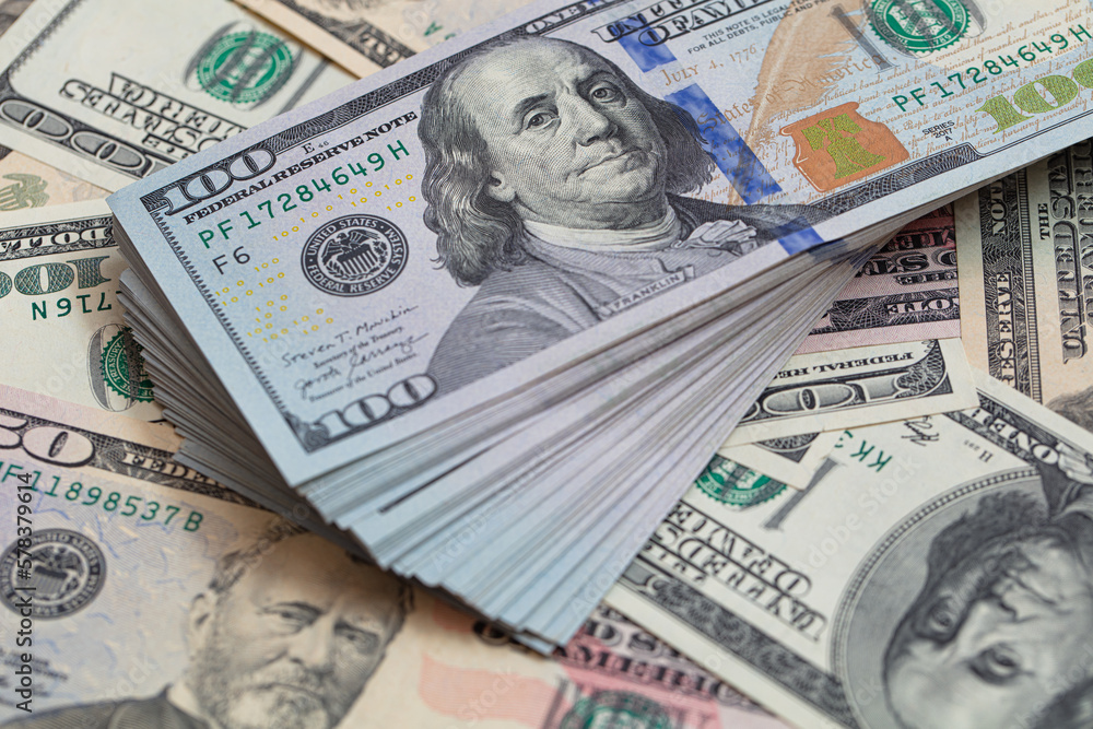 Pile of 100 dollar banknotes on dollar background Pile of 100 dollar banknotes on dollar background