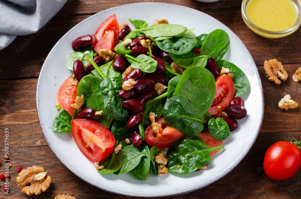 Red Bean Salad On Wooden Background, Fresh Salad with Spinach, Cherry Tomatoes, Walnuts, Beans and Mustard Dressing Red Bean Salad On Wooden Background, Fresh Salad with Spinach, Cherry Tomatoes, Walnuts, Beans and Mustard Dressing