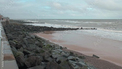 View over Sheringham beach, on the North Norfolk coast, as the waves roll in on a dull and grey winter’s day photo