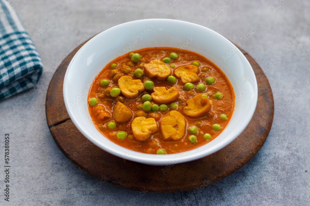 Spicy button mushroom curry cooked with green peas. Spicy button mushroom curry cooked with green peas.