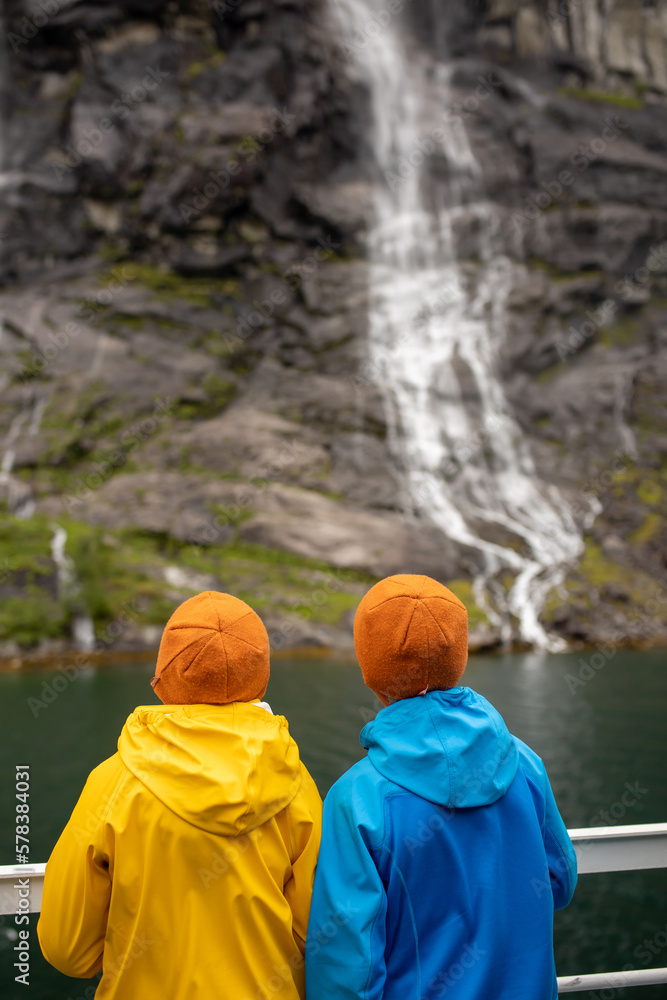 Fototapeta premium Family, kids and adults and a pet dog, enjoying trip to Geirangerfjord, amazing nature in Norway