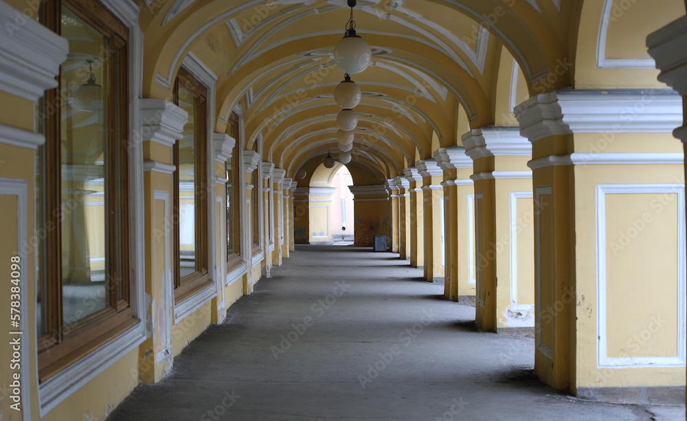 Yellow arched Colonnade of the Old Gostiny Dvor, Dumskaya Street, St. Petersburg, Russia,  february2023