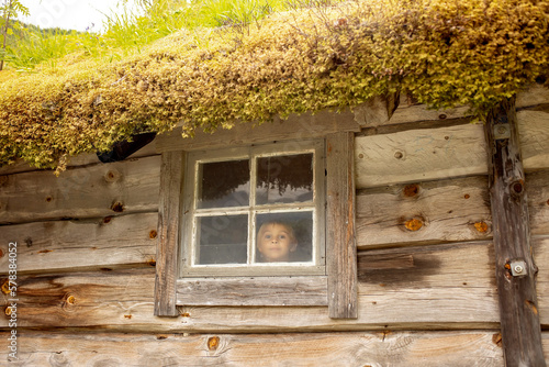 Amazing little wooden small house next to a waterfall on the dock of Hellesylt, child playing in the house photo