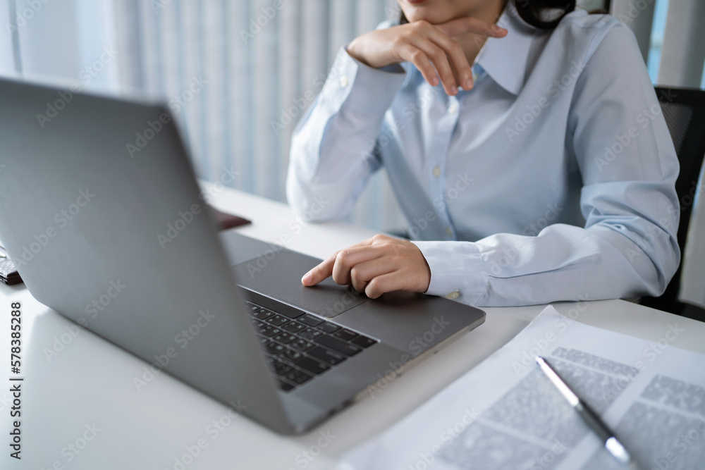 Asian Woman working by using a laptop computer Hands typing on keyboard. Working at office professional investor working new start up